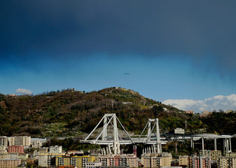 Il lato est del ponte Morandi e le case evacuate. Nuvola tempestosa sopra la collina.
