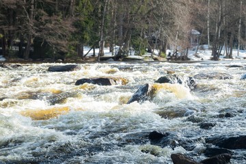 Rough river Jokelanjoki and stones in water, Kouvola, Finland.