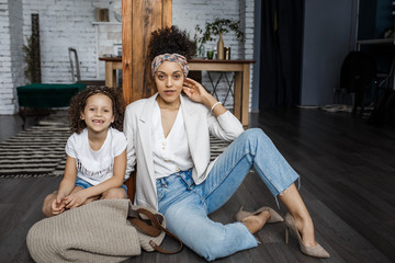 Obraz premium Happy loving family. Young mother and her daughter girl play in kids room. Funny mom and lovely child