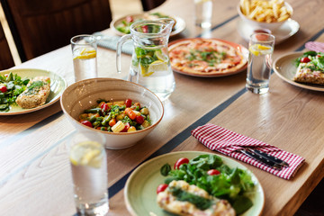From above view of homemade dishes and drinks served on dinner table