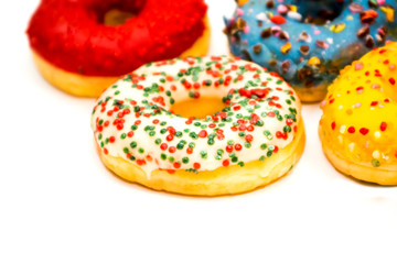 Sweet tasty donuts with colorful sprinkles isolated on white background