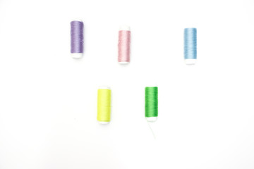 Sewing supplies on white background