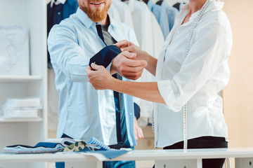 Man in fitting of a bespoke shirt in studio of tailor