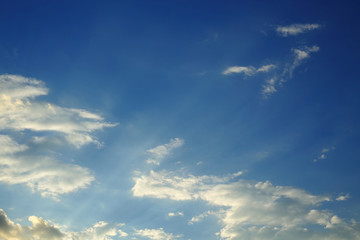 sunlight shine through cloud on dramatic blue sky background
