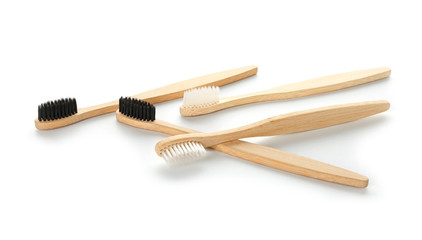 Wooden toothbrushes on white background