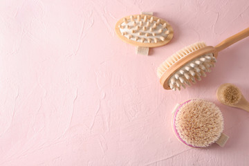 Massage brushes on color background