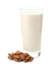 Glass of almond milk on white background