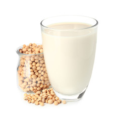 Glass of soy milk on white background