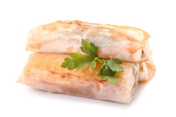 Tasty fried spring rolls on white background