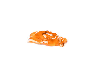 Pouring liquid caramel on white background