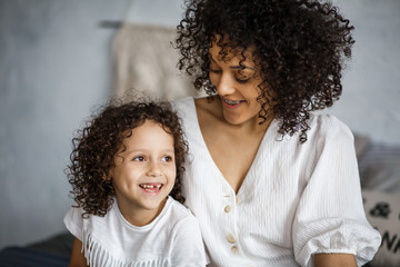 Obraz premium Happy Women's Day. Mom and daughter. Mom and girl are smiling with braces of African-American appearance.