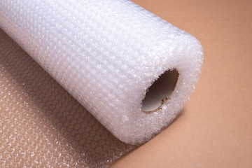 Roll of bubble film on Cardboard background