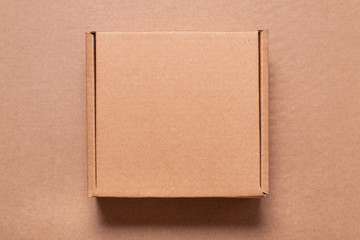 Cardboard box on brown carton background