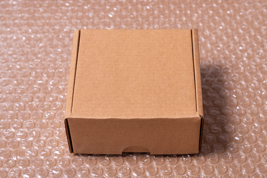 Cardboard box on bubble wrap film