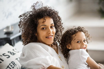 Happy Women's Day. Mom and daughter. Mom and girl are smiling with braces of African-American appearance.