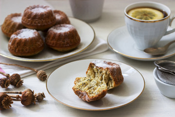 Lemon poppy biscuit muffins for tea on a light background.