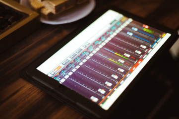 Mixing music on tablet with electronic music instruments concept