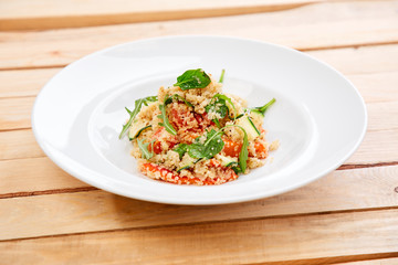 An easy, zesty summer salad with a Mediterranean flair featuring Israeli couscous and chopped summer vegetables