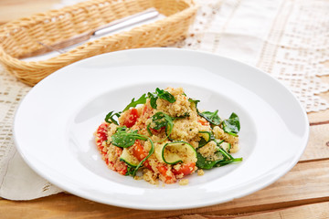 An easy, zesty summer salad with a Mediterranean flair featuring Israeli couscous and chopped summer vegetables