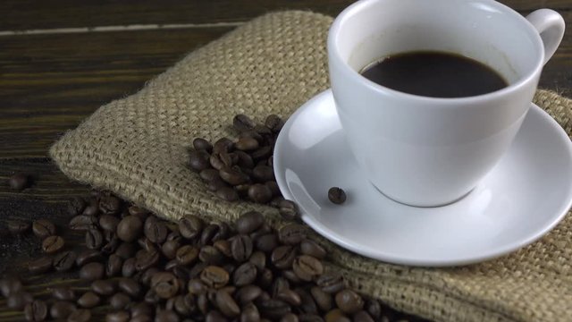 Cup of coffee on a rough wooden background