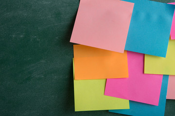 Colorful sticky notes on the blank blackboard