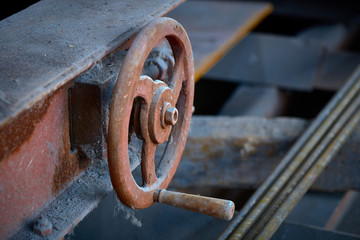 turn the wheel. old rusty detail of a shipping mechanism in an abandoned factory