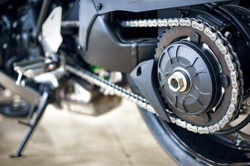 View of the back of a motorcycle with an emphasis on the chain.