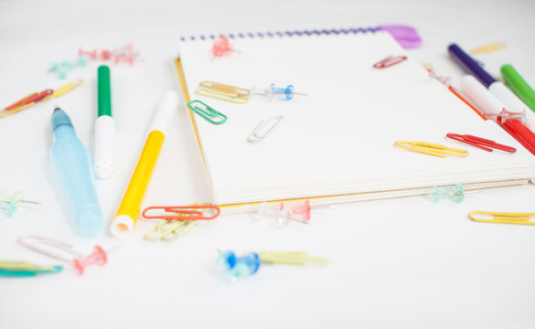 Bright stationery for study: paper, felt-tip pens, scissors, paper clips