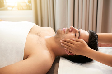 Obraz na płótnie Canvas Man receiving face massage at spa