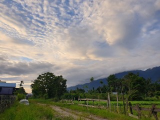 Fototapeta premium landscape with blue sky and clouds, mountain views from the village