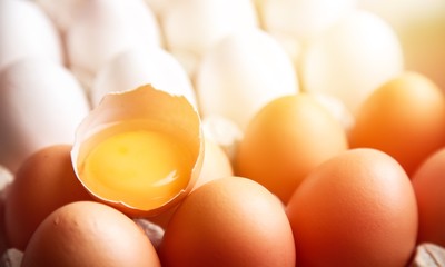 Broken Egg With Yolk On Eggs In Carton Egg Tray Close-up