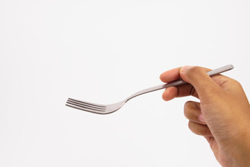 A hand holds steel silver fork isolated on white background 