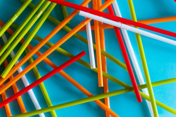 Colorful Plastic Cocktail Tubes Over Blue Background. Abstract Colorful Diagonal Lines.
