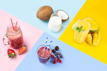 Selection of colourful smoothies in glasses with ingredients