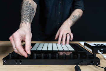 Dj man creates electronic music in the studio