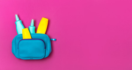 Female cosmetics bag, cosmetic products, yellow sunscreen bottle and sunblock lotion, spray on...
