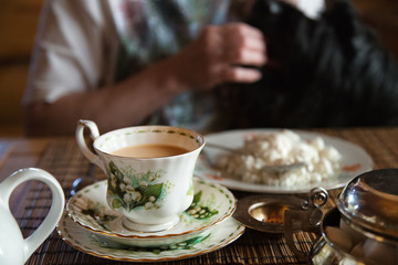 Homemade breakfast. Tea with milk and cottage cheese. Morning tea. Cosy home.