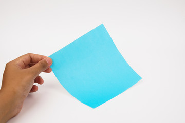A hand holds blank blue paper on a white background.