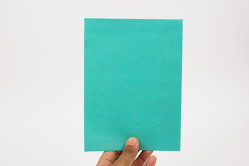 A hand holds blank turquoise paper on a white background.