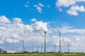 Wind turbines against cloudy sky