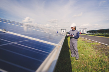 engineers repairing solar panel at generating power of solar power plant ; technician in industry...