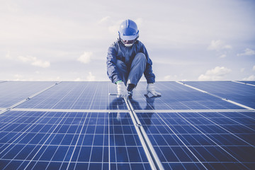 engineers repairing solar panel at generating power of solar power plant ; technician in industry...