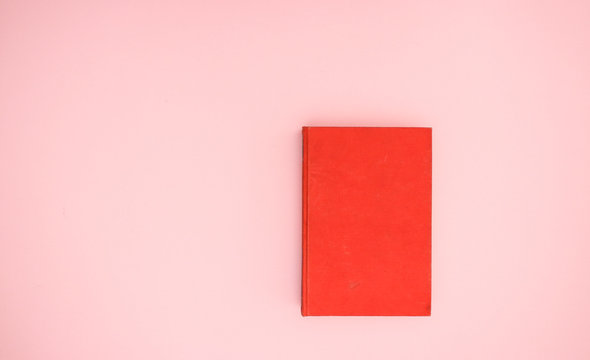 Red book on pink background