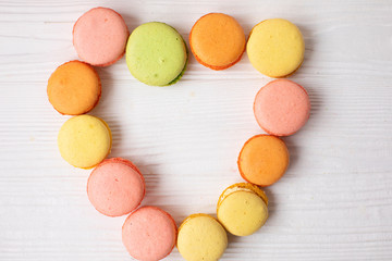 A lot of colorful candy. Overhead view of colorful array of different childs sweets and treats in bowls on light red background