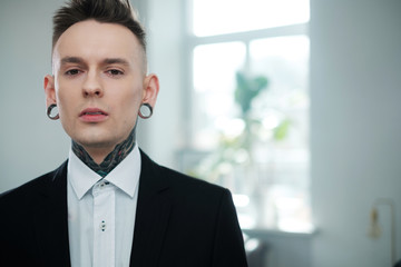 Portrait of alternative model with earplugs and tattoo