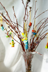 A bouquet of willow twigs with Easter decorations: small figures of eggs, rabbits and chickens