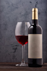 red wine and grapes. Wine and grapes in vintage setting with corks on wooden table.