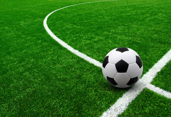 Soccer ball on green football field