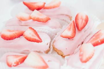 Sweet background. Eclairs with strawberries