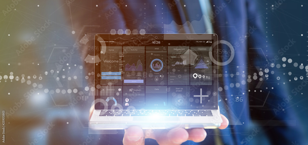 Poster businessman holding laptop with business user interface data on the screen isolated on a background